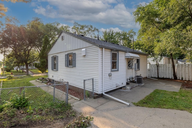 view of side of property featuring central AC and a patio area