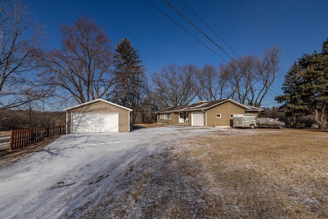 view of side of property featuring a garage and an outdoor structure