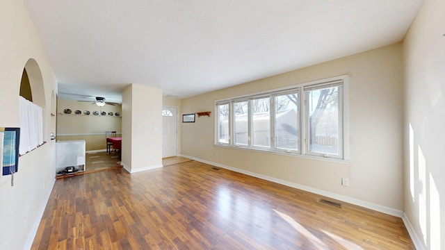 unfurnished living room with dark hardwood / wood-style flooring