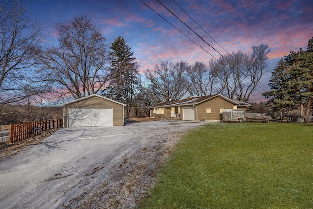 exterior space with a garage, a yard, and an outdoor structure