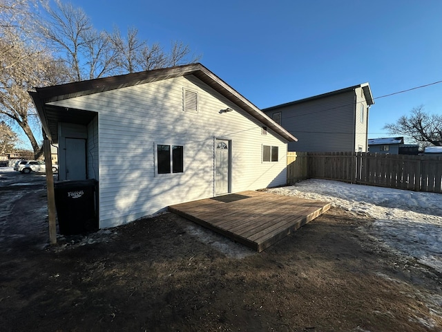 rear view of property featuring a wooden deck