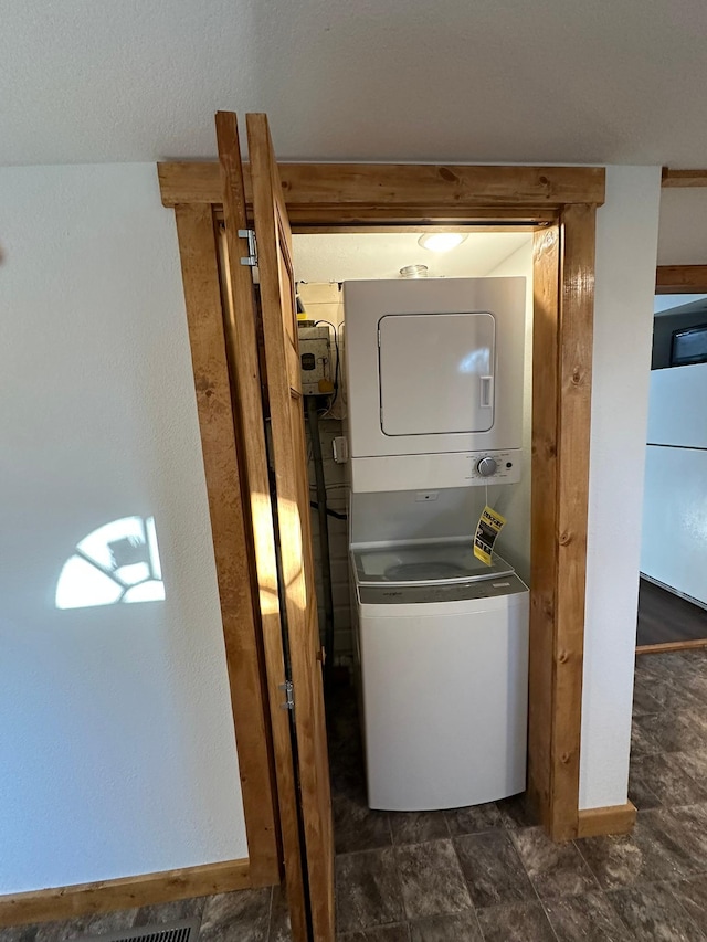 laundry area featuring stacked washing maching and dryer