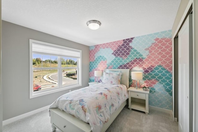 carpeted bedroom featuring a textured ceiling