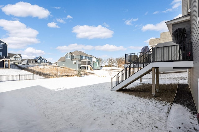 yard layered in snow with a wooden deck