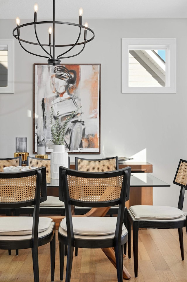 dining room with a notable chandelier and wood-type flooring