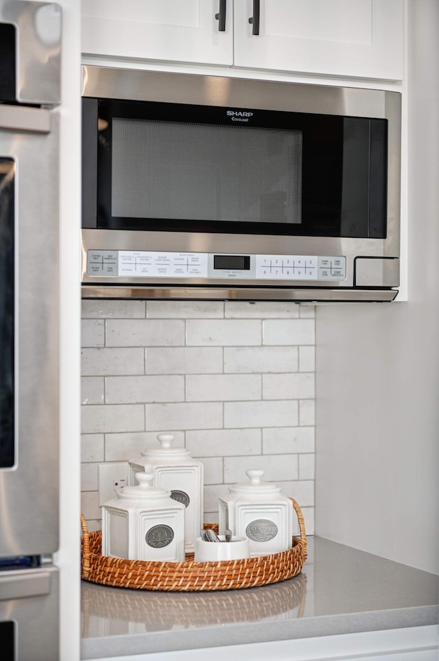 details with white cabinetry and stainless steel appliances