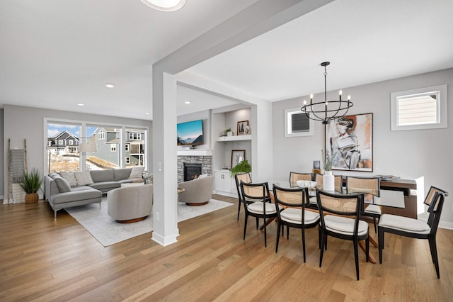 dining space featuring plenty of natural light, a fireplace, and light hardwood / wood-style floors