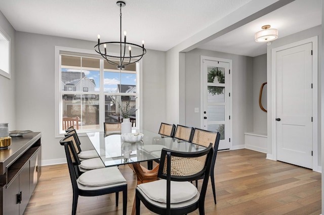 dining room with a notable chandelier and light hardwood / wood-style flooring