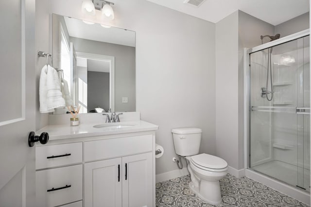 bathroom with vanity, toilet, tile patterned flooring, and a shower with door