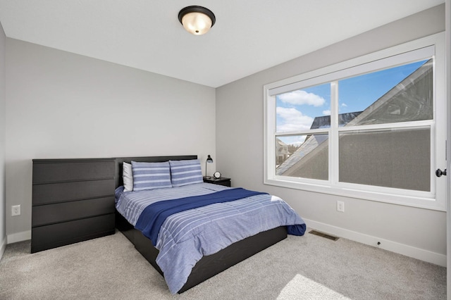 bedroom with light colored carpet