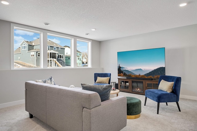 carpeted living room featuring a textured ceiling