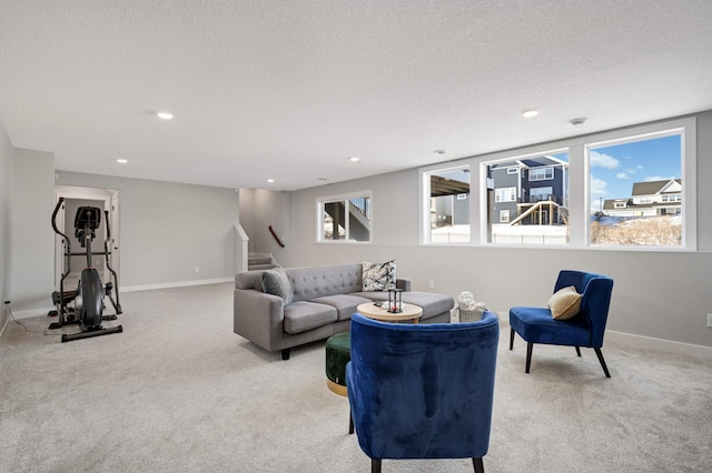 carpeted living room with a textured ceiling