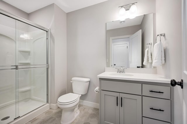 bathroom featuring vanity, toilet, and an enclosed shower