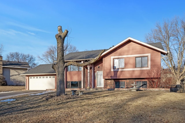 view of front of property featuring a garage and a front lawn