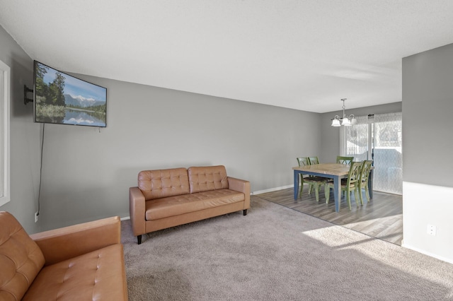 living room featuring an inviting chandelier and light colored carpet