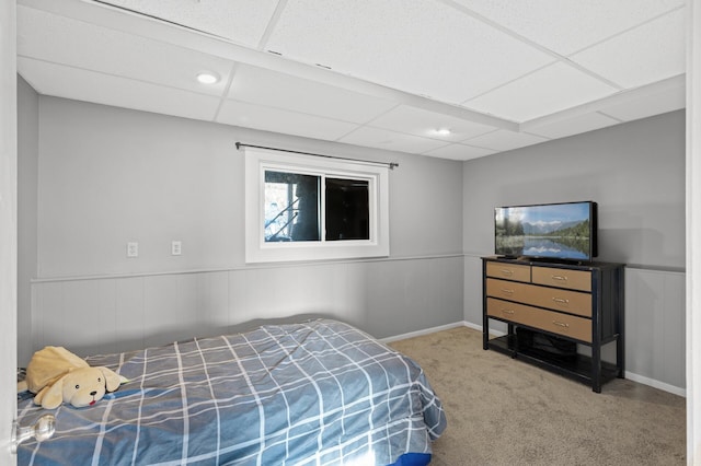 carpeted bedroom with a paneled ceiling