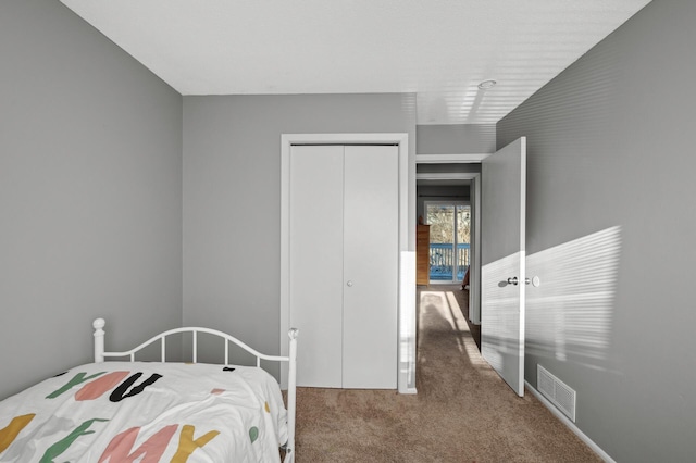 carpeted bedroom featuring a closet