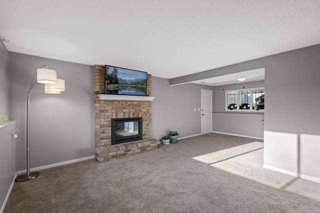 unfurnished living room with a brick fireplace, a textured ceiling, and carpet