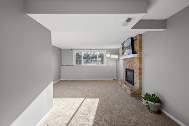 unfurnished living room with a brick fireplace, carpet, and a textured ceiling