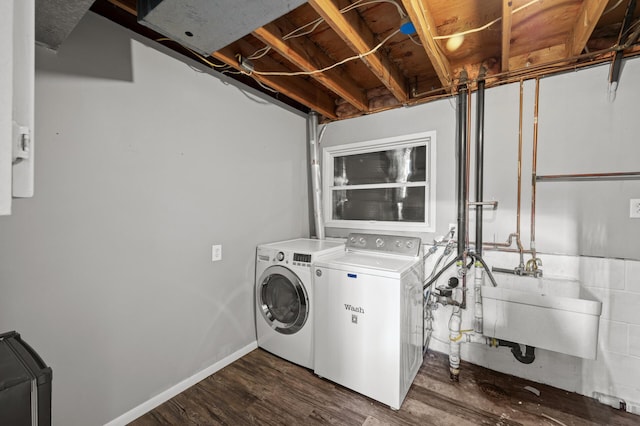 laundry area with sink, dark wood-type flooring, and washer and clothes dryer