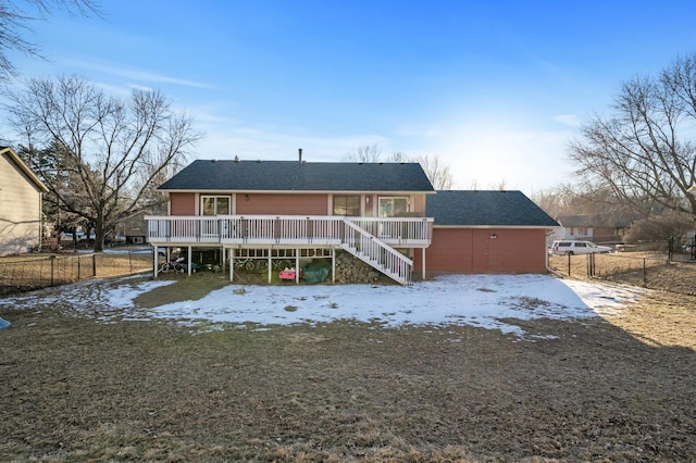 rear view of property featuring a wooden deck