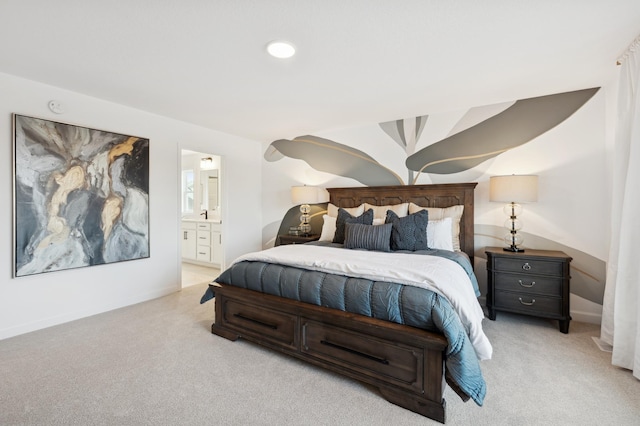 bedroom featuring ensuite bathroom, lofted ceiling, and light carpet