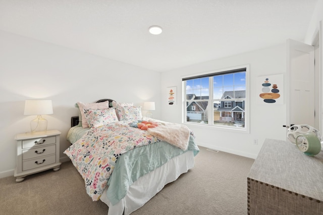 bedroom featuring light carpet