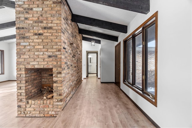 hallway with beam ceiling and hardwood / wood-style flooring