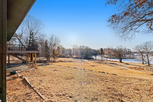 view of yard featuring a deck with water view