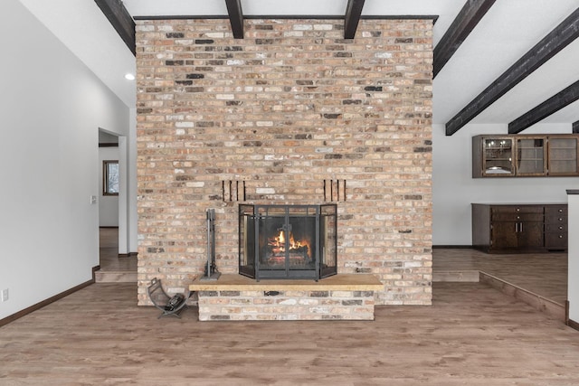 details with hardwood / wood-style flooring, a fireplace, and beam ceiling