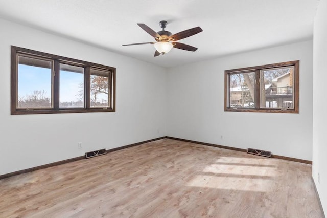 spare room with light hardwood / wood-style flooring and ceiling fan