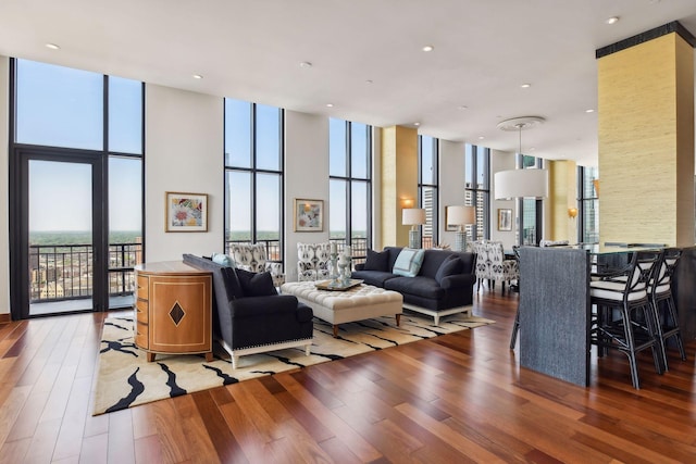 living room with a wall of windows and wood-type flooring