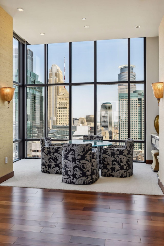 interior space with a wealth of natural light, wood-type flooring, and floor to ceiling windows