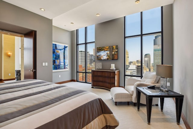 201 11th St Unit 2600, Minneapolis, MN 55403 - bedroom with baseboards, light carpet, a towering ceiling, and recessed lighting