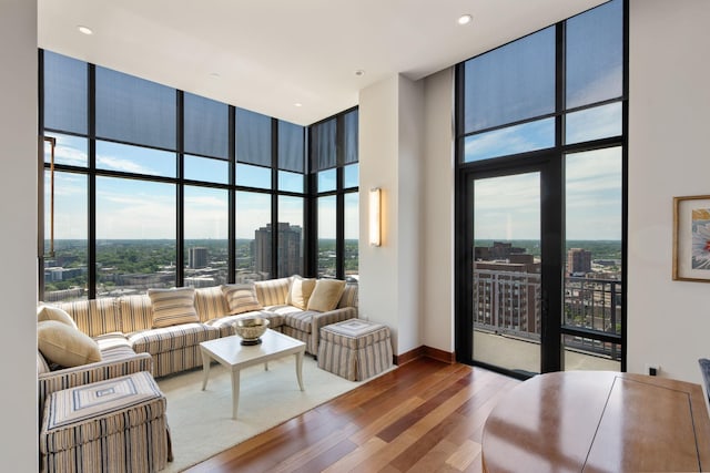 201 11th St Unit 2600, Minneapolis, MN 55403 - living room with a high ceiling, wood finished floors, floor to ceiling windows, and baseboards