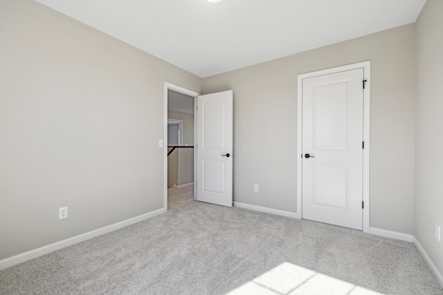 unfurnished bedroom featuring light carpet