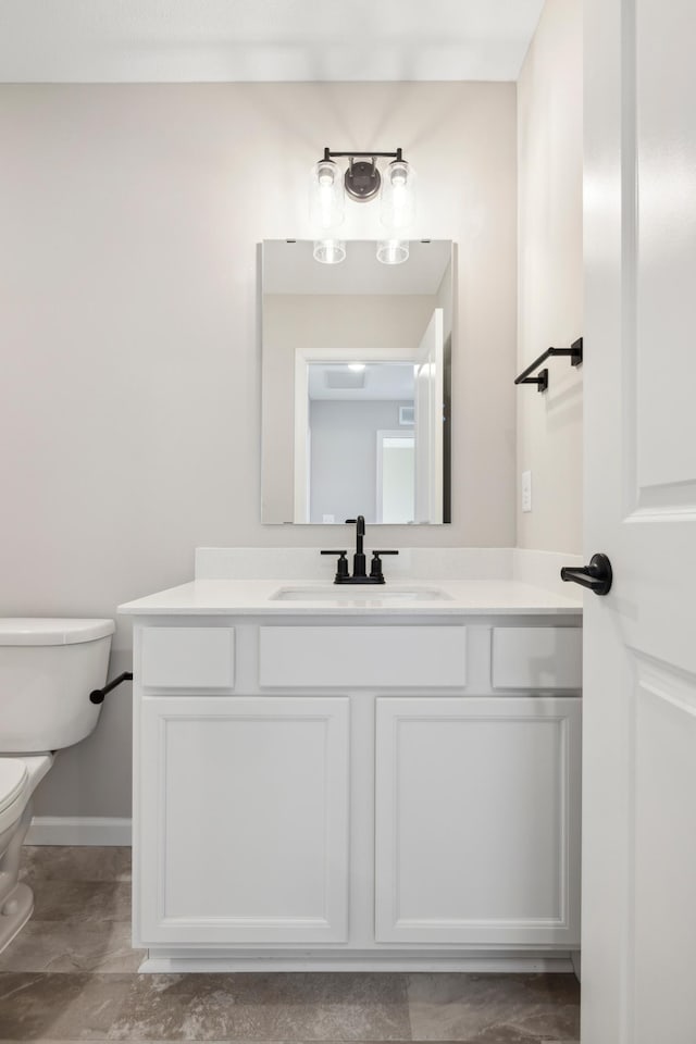 bathroom featuring vanity and toilet