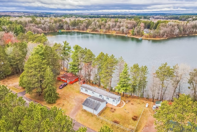 birds eye view of property with a water view and a view of trees