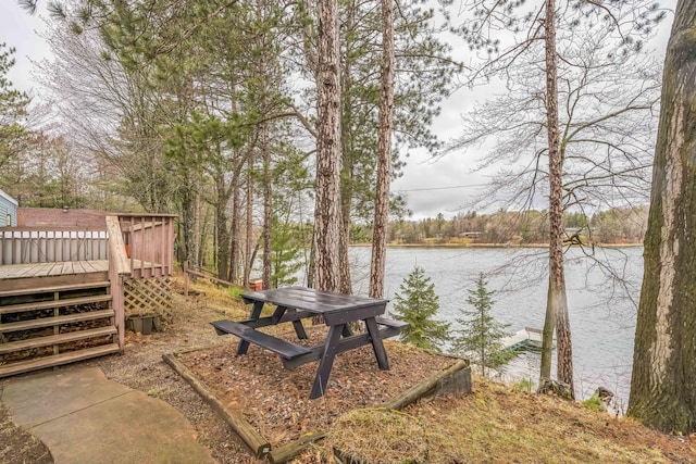 exterior space featuring a deck with water view