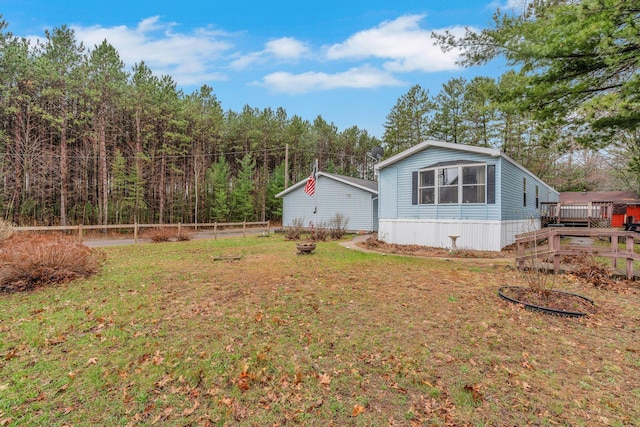 exterior space with a yard, fence, and a wooden deck
