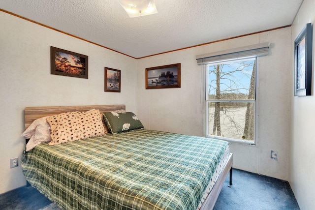 carpeted bedroom featuring ornamental molding and a textured ceiling
