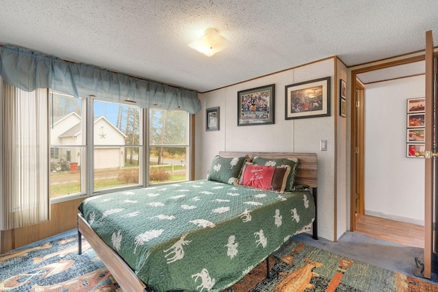 bedroom featuring crown molding and a textured ceiling