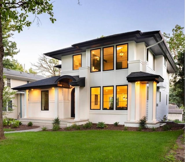 exterior space featuring a front lawn and stucco siding