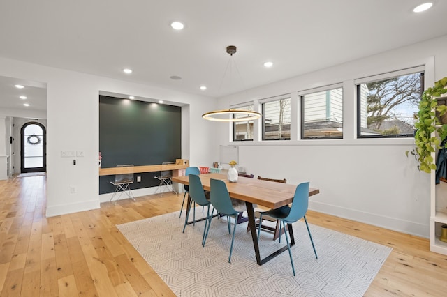 dining area featuring baseboards, wood-type flooring, and recessed lighting