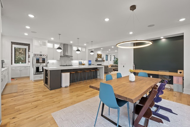 dining space with light wood-style floors and recessed lighting