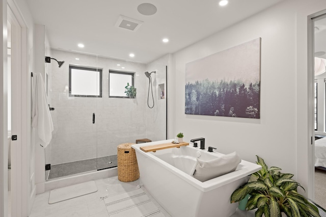 bathroom with a stall shower, a soaking tub, connected bathroom, and recessed lighting