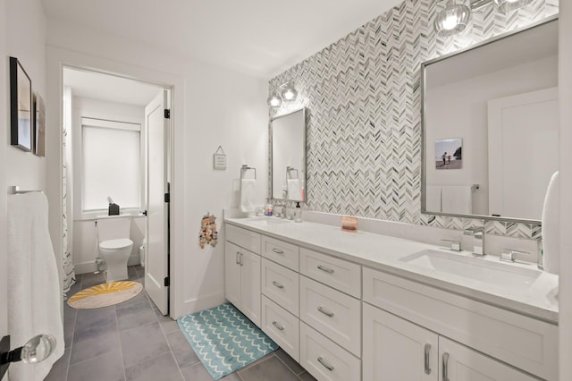 full bath featuring toilet, tile patterned flooring, decorative backsplash, and a sink