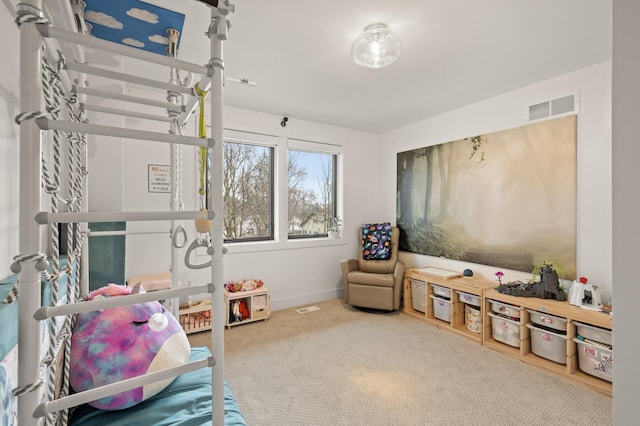 rec room with carpet, visible vents, and baseboards