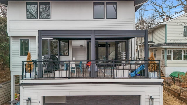 back of house featuring a balcony