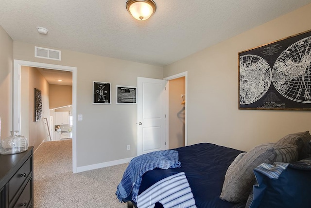 carpeted bedroom featuring a textured ceiling